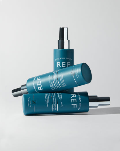 lifestyle image of 3 bottles REF Stockholm  Detangling Spray 175ml